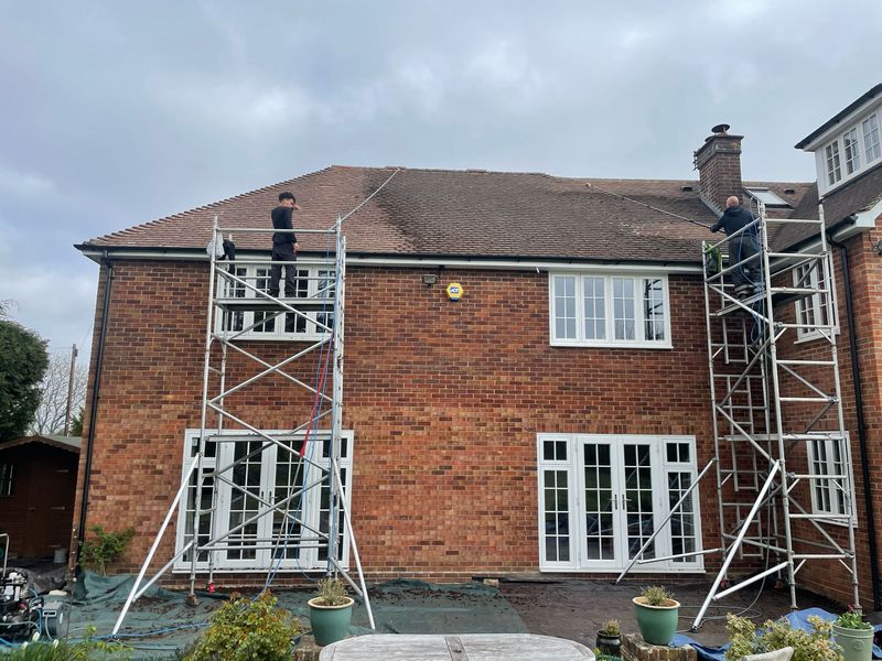 Roof cleaning carried out safely from scaffold towers by The Roof Moss Cleaners in Hindhead
